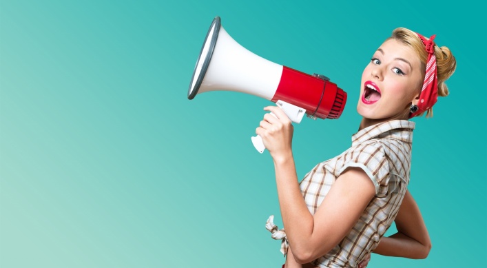 Portrait of woman holding megaphone, dressed in